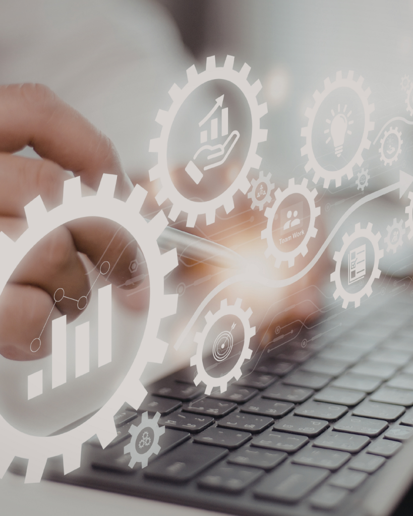 Laptop with gear icons floating above it.