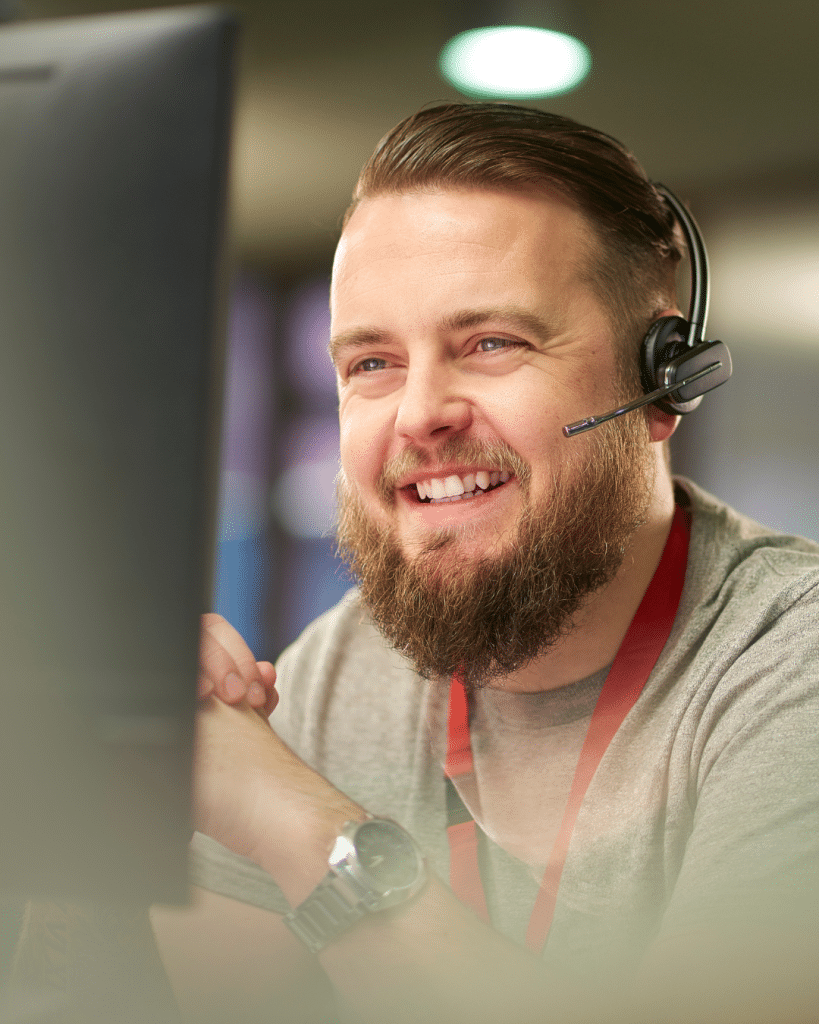 Man smiling at computer with headset Toronto it service