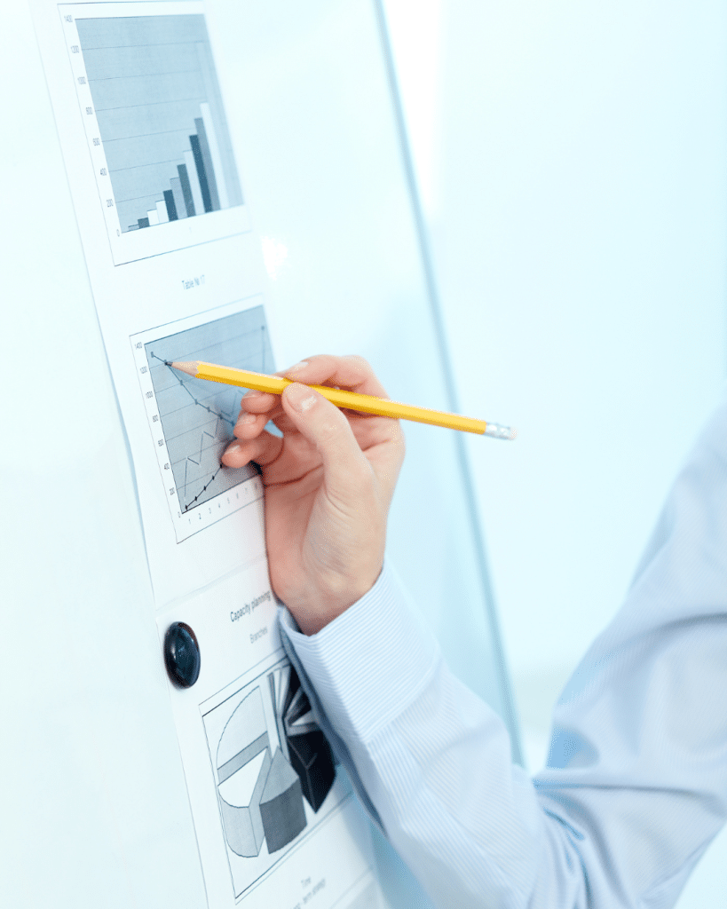 HaaS and Procurement 7 hand hold pencil to graph.