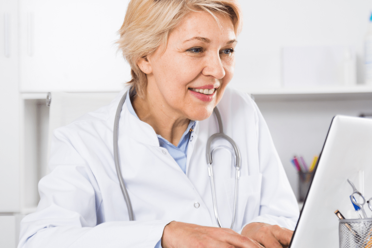 Calgary healthcare professional confidently reviewing AI-powered patient analytics on a secure PIPEDA and HIA compliant workstation representing PCe Solutions Managed Intelligence AI services for Calgary healthcare organizations across Alberta