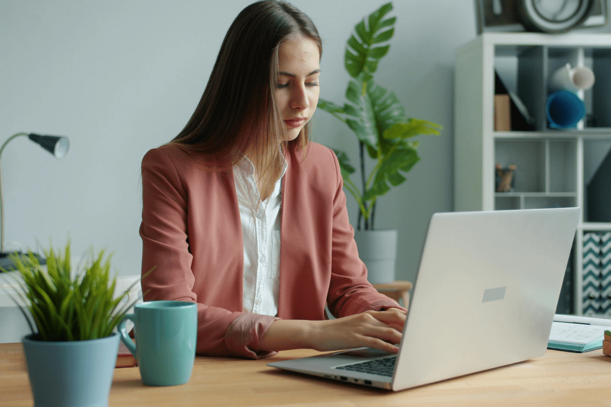 Calgary business professional working confidently with cloud-based tools across multiple screens in a modern Downtown Calgary or Quarry Park office environment representing PCe Solutions cloud services and managed cloud migration for Alberta businesses