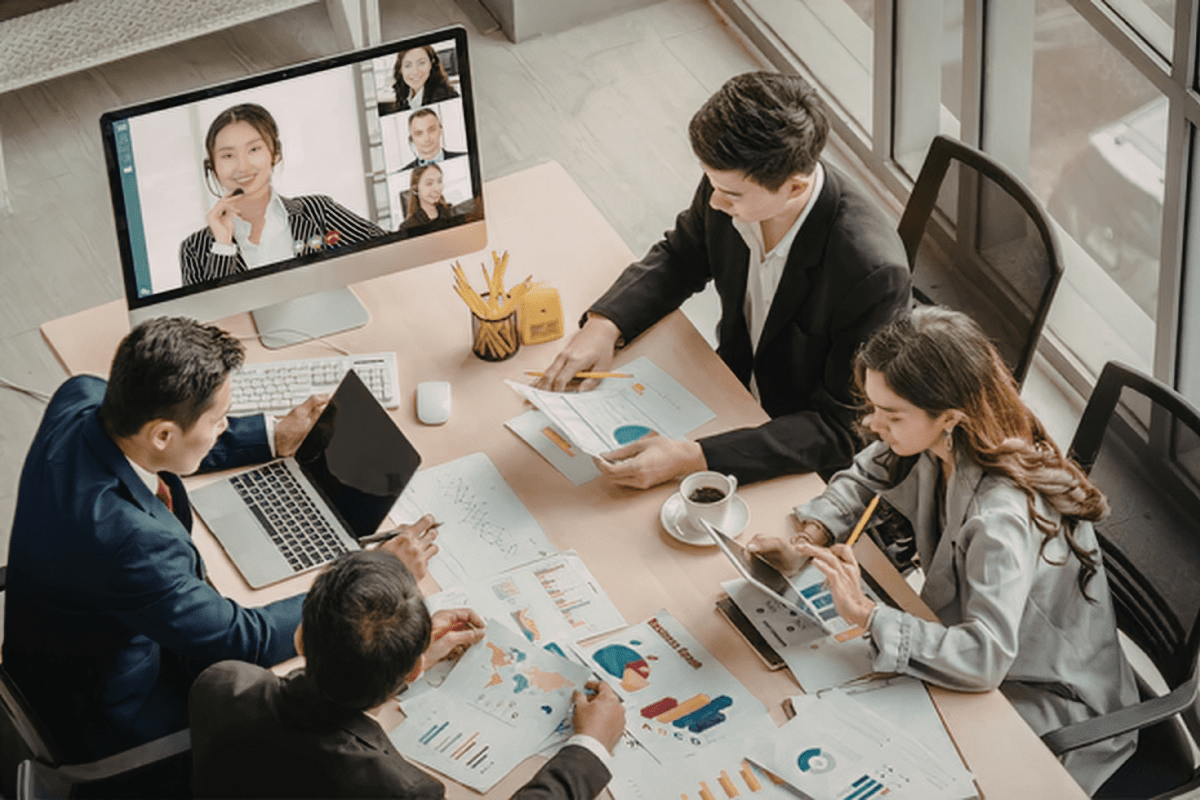 Calgary business professionals using modern video conferencing and unified communications technology in a contemporary office environment representing PCe Solutions VoIP and unified communications services for Calgary Alberta businesses